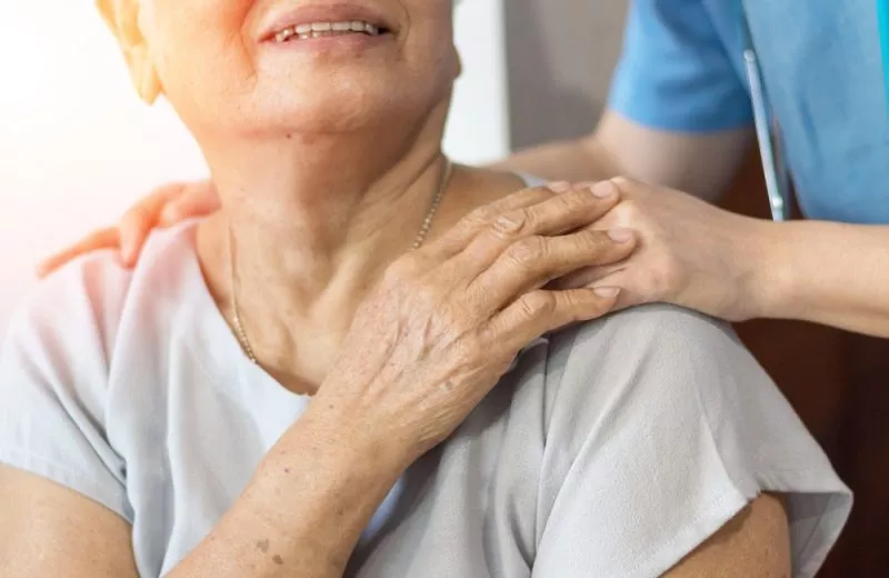 A public health nurse provides care for an elderly patient.