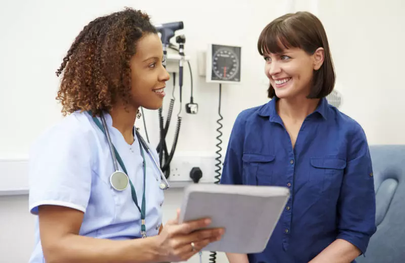 A nurse practitioner speaks to a patient.